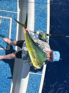 Angler Holding Mahi Mahi Fish
