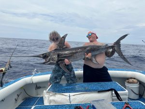 Fishermen Holding Swordfish Boat